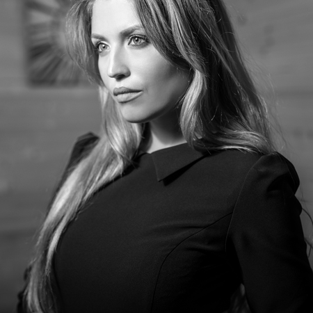 Elegant young beauty woman in interior black-white portrait.の写真素材