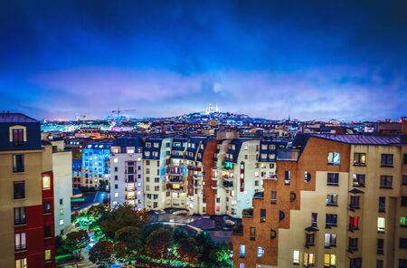 Night top view of the Montmartre and roofs of autumn rainy Paris.の写真素材