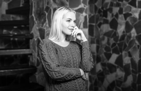 Young blond beauty woman against house interior.  Black-white portrait.の写真素材