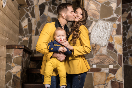 Young happy family together in interior of house.の写真素材