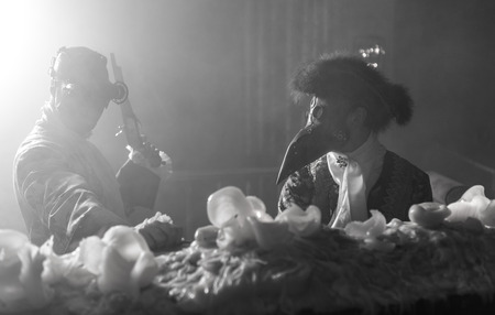 Actors in Steam punk masks and antique costumes indoor. Black-white photo.の写真素材