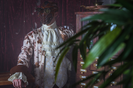 Actor in steam punk masks and antique costumes indoor. の写真素材