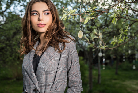 Outdoors portrait of beautiful young woman posing in summer garden.の写真素材