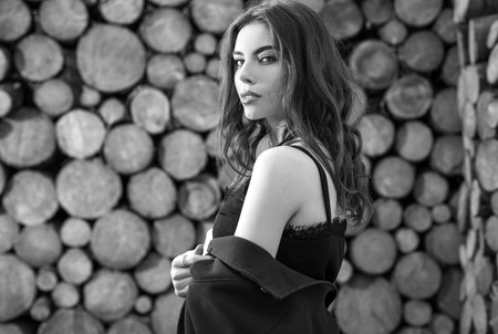 Beautiful women portrait against wooden wall. Black-white photo.の写真素材
