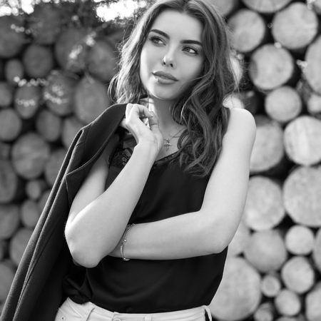 Beautiful women portrait against wooden wall. Black-white photo.の写真素材