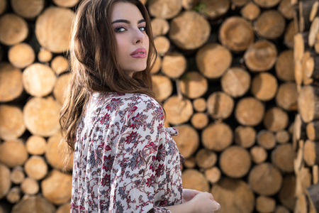 Beautiful women portrait against wooden background.