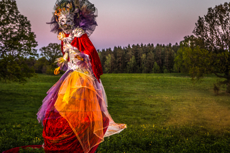 Fairy tale woman on stilts in bright fantasy stylization. Fine art outdoor photo. の写真素材