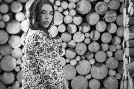Beautiful women portrait against wooden wall. Black-white photo.の写真素材