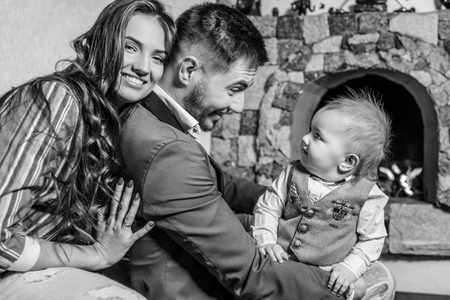 Young happy family together in interior of house. Black-white portrait.の写真素材