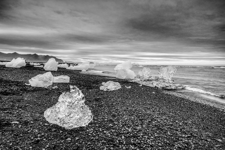 Glaciers on beaches of Iceland. Black-white photo.