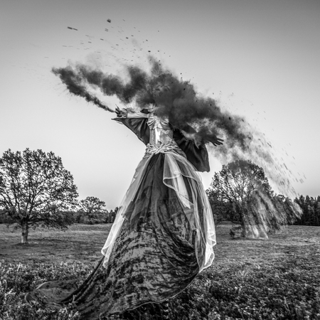 Fairy tale woman on stilts in fantasy stylization. Fine art black-white photo.