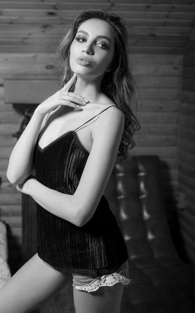 Young beauty woman pose against house interior.の写真素材