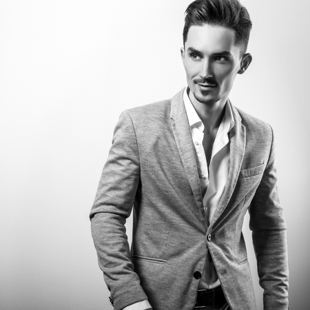 Handsome young elegant man in grey jacket. Black-white portrait.の写真素材