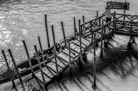 VENICE, ITALY - AUGUST 17, 2016: Traditional gondolas on narrow canal close-up on August 17, 2016 in Venice, Italy.のeditorial素材
