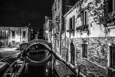 VENICE, ITALY - AUGUST 21, 2016: Famous architectural monuments, ancient streets and facades of old medieval buildings at night time close-up on August 21, 2016 in Venice, Italy.のeditorial素材