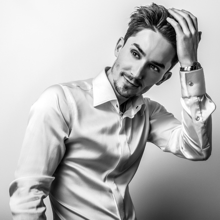 Elegant young handsome man. Black-white studio photo.の写真素材