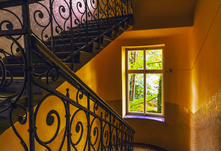 Ancient stairs in porches of European vintage buildings.の写真素材