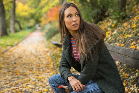 Portrait of beautiful young girl in picturesque autumn park.