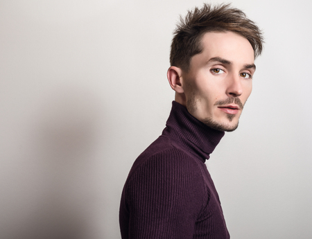 Handsome young elegant man in violet golf.の写真素材