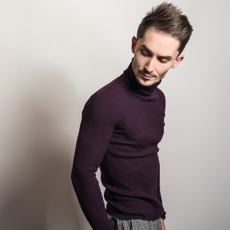 Handsome young elegant man in violet golf.の写真素材