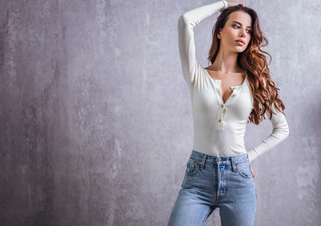 Beautiful young woman pose in modern interior.