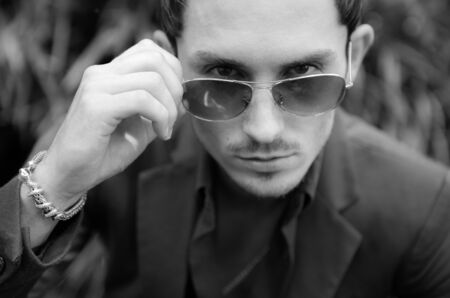Young elegant handsome man posing outside.の写真素材