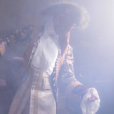 Actors in Steam punk masks and antique costumes indoor.