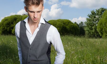 Young elegant handsome man posing outside.の写真素材
