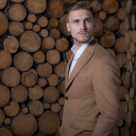Portrait of handsome young man on wooden background.の写真素材
