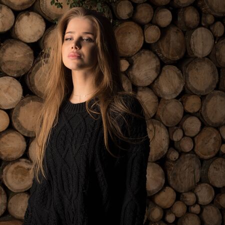 Portrait of beautiful young girl on wooden background.の写真素材