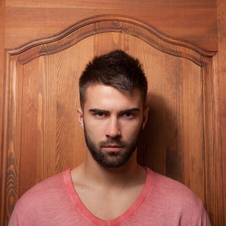 Handsome young elegant man in house interior.の写真素材