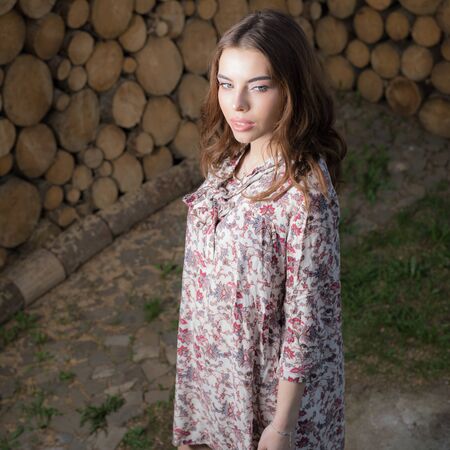 Portrait of beautiful young girl on wooden background.の写真素材
