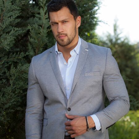 Young elegant handsome man posing outside.の写真素材