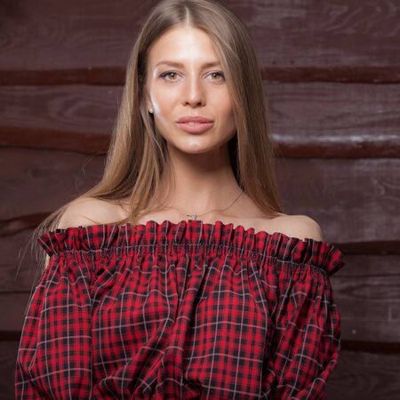 Portrait of beautiful young girl on wooden background.の写真素材