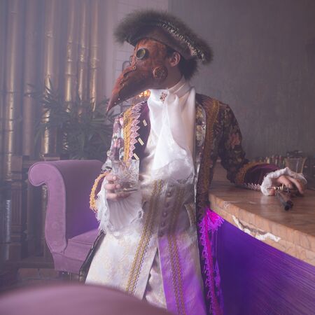 Actors in Steam punk masks and antique costumes indoor.