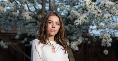 Portrait of beautiful young girl in summer garden.