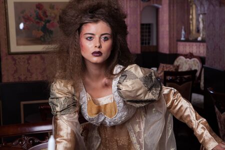 Victorian stylized fashion model in antique interior.の写真素材