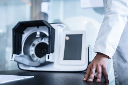BEIJING, ?HINA - JUNE 01, 2019: Doctors hands close-up against modern health diagnostic equipmentのeditorial素材