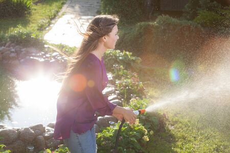 Portrait of beautiful young girl in summer garden.