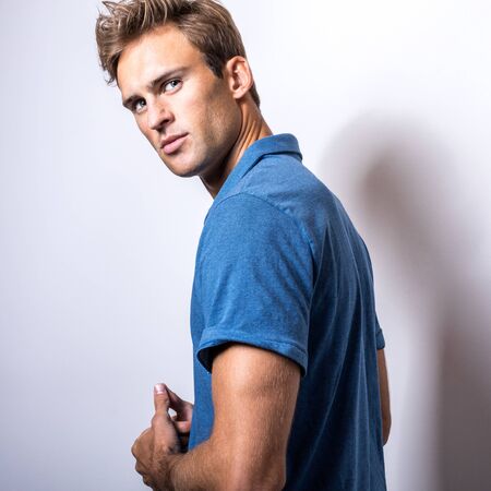 Elegant young handsome man in stylish blue shirt.の写真素材