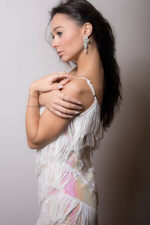 Young beautiful stylish girl posing in studio.の写真素材