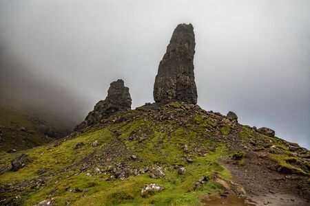 Old Man of Storr on the Isle of Skye in Scotland. Mountain landscape with foggy clouds.の写真素材