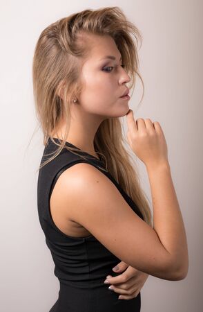 Young beautiful stylish girl posing in studio.の写真素材