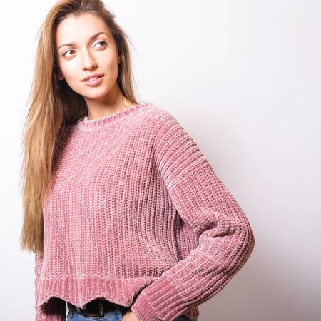 Young model woman in sweater pose in studio.の写真素材