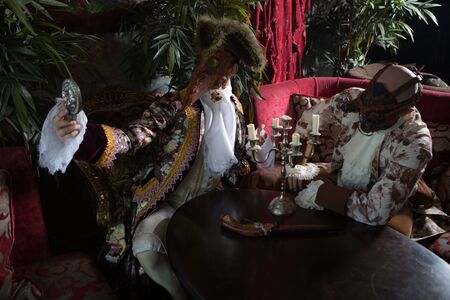 Actors in Steam punk masks and antique costumes indoor.の写真素材