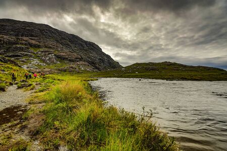 Traveler walk against beautiful Scotland nature photo.の写真素材