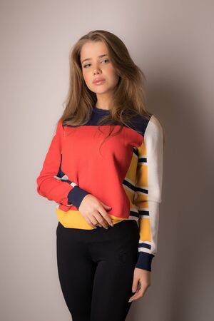 Young beautiful stylish girl posing in studio.の写真素材