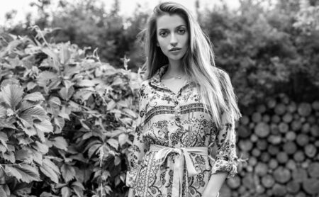 Beautiful emotional black-white portrait of young woman outdoor.の写真素材