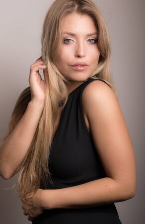 Young beautiful stylish girl posing in studio.の写真素材