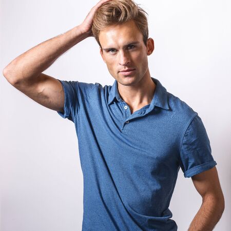 Elegant young handsome man in stylish blue shirt.の写真素材